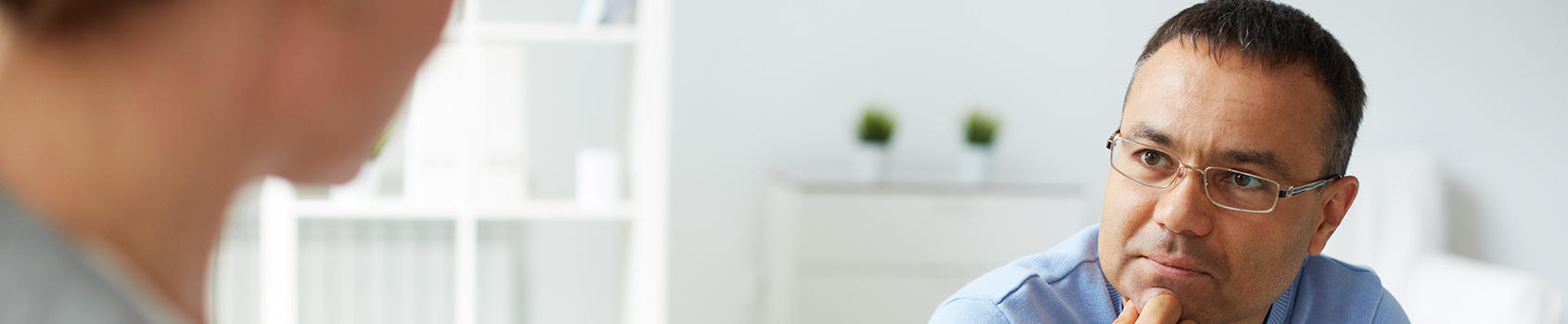 man listening intently to another person talking